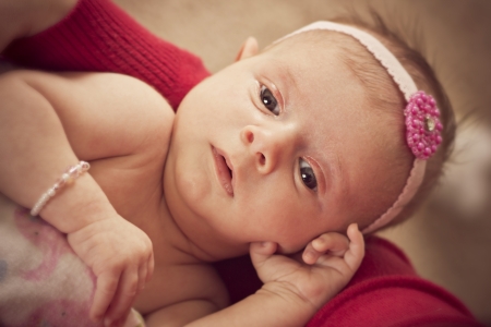 Newborn baby girl in her mothers armsの写真素材
