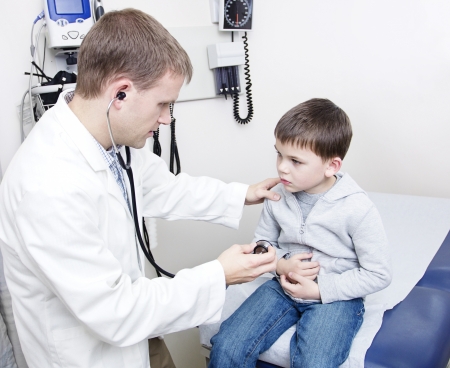 Doctor Examining sick little boyの写真素材