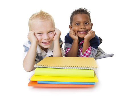 Two diverse little school children with their booksの写真素材