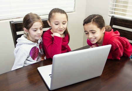 Kids playing on the computer together