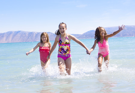 Kids Playing in the water at the beachの写真素材