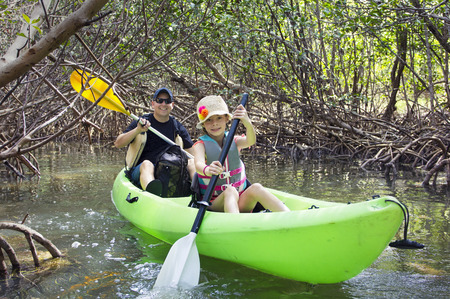 Family kayaking through tropical mangrove forestの写真素材