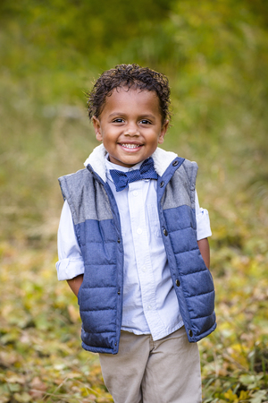 Cute outdoor portrait of a smiling African American boyの写真素材