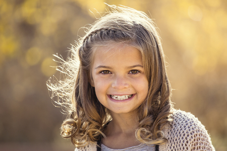 Beautiful Portrait of smiling little girl outdoorsの写真素材