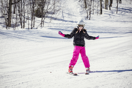 Young skier learning to ski downhillの写真素材