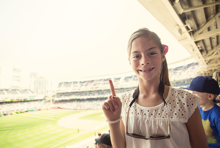 Happy Child enjoying a day at a baseball gameの写真素材