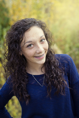 Beautiful Hispanic Teen Girl portrait with braces on her teethの写真素材