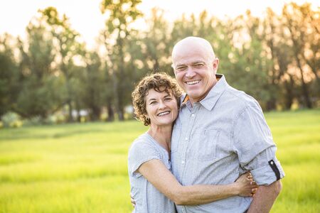 Attractive Smiling Mature couple portrait outdoors. Senior husband and wife in their 50s enjoying the success and prosperity of lifeの写真素材