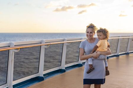 A mother and her son enjoying a Caribbean Cruise vacation together. Candid photo of a family enjoying their time on board a cruise ship together.の写真素材