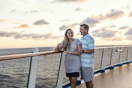 Middle aged couple enjoying a Caribbean Cruise vacation together. Candid photo of a couple holding enjoying their time on board a cruise ship togetherの写真素材