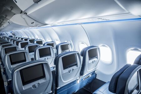 Interior of an empty airplane. View from the back of the plane. Nobody on the plane. Abstract air travel photo.の写真素材