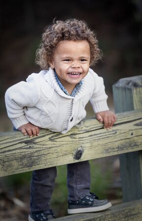 Portrait of a Happy cute young diverse boy outdoors. Excited and fun expression of a biracial little child.の写真素材