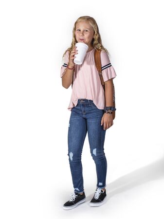 Full length isolated photo of a Smiling teen girl drinking a soda drinkの写真素材