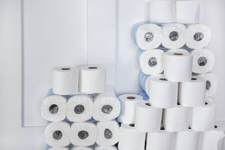 Large stack of toilet paper rolls in a home. Home preparedness for emergency situations. Stocking up on the essentials.の写真素材