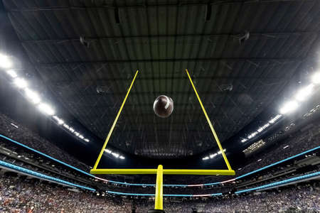 Field Goal Posts in a large indoor football stadium during a game. Generic Football background image