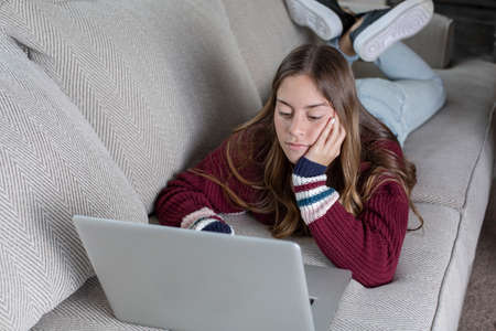 Teen student doing online school work from homeの写真素材
