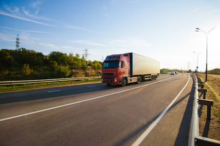 Red truck on the road with blurred backgroundの写真素材