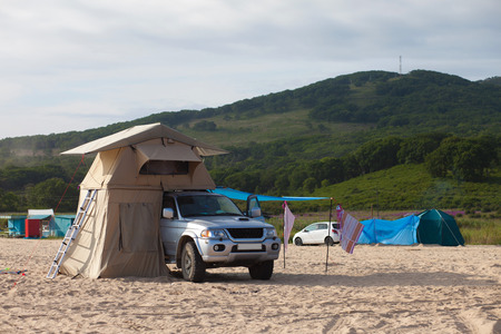 Car with roof tent at the sea shoreのeditorial素材
