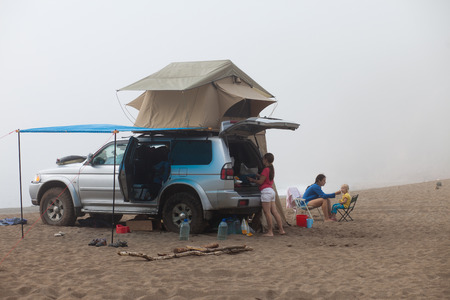 Car with roof tent at the sea shore