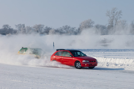 Red car moving on snow with blurred background