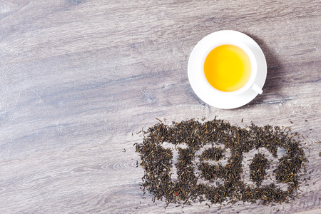 Words I love tea made of green tea leaves on wood background.の写真素材