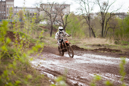 Motocross rider moving on a mud trackの写真素材
