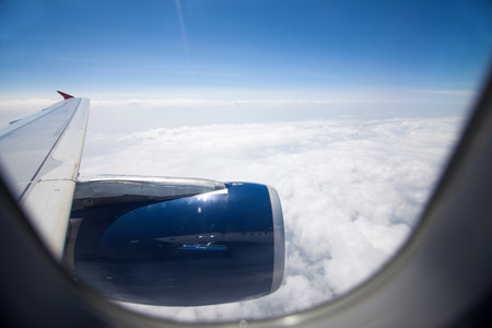 Looking to airplane engine through the window during flight from inside of planeの写真素材