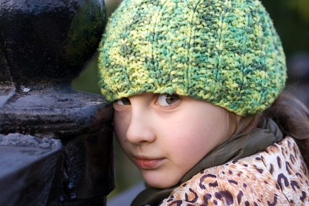 Portrait of cute little girl in knitted hatの写真素材