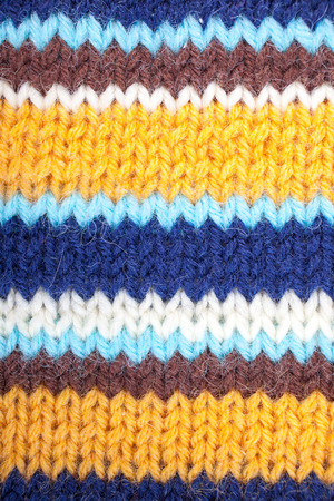 Stripped knitted background. Blue, white, orange, brown and turquoise
