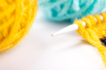 Knittes canvas, knittinf needle and two yarn ballsの写真素材