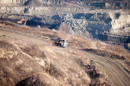 Yellow dump truck moving by the road to coal mineの写真素材