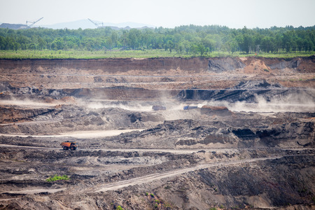 Dump trucks working at open coal mine