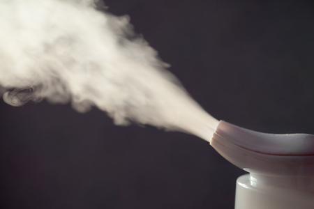 Humidifier spreading steam in darkness