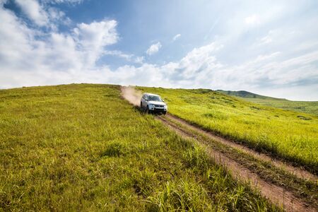 Primorye, Russia - August 2, 2018: Mitsubishi Pajero goes down the hill by dirt road
