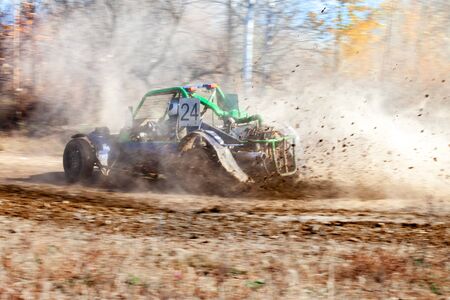 Buggy racing. Mud splashes from wheels. Motion blurred background