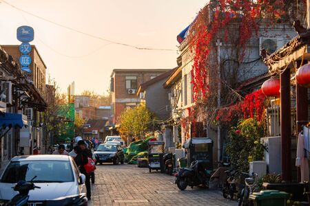 Beijing, China - November 11, 2019: Red autumn leaves on the wall at one of small Beijing streets (hutong)のeditorial素材