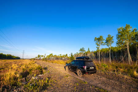 Khabarovsk, Russia - May 23, 2020: Subaru Forester with roof box at dirt road in the forest