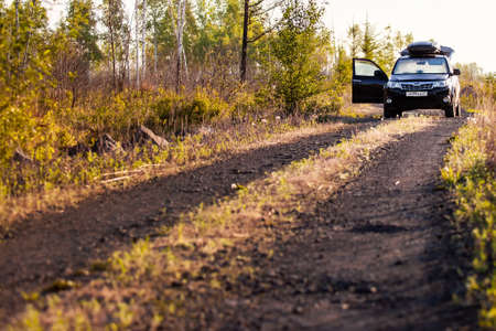 Khabarovsk, Russia - May 23, 2020: Subaru Forester with roof box at dirt road in the forest
