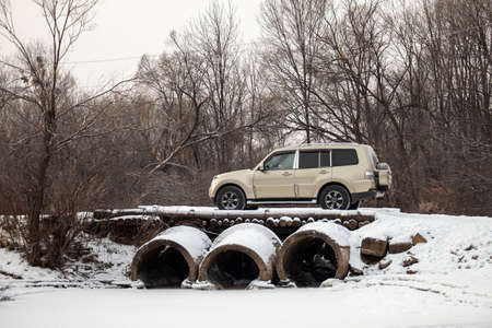 Khabarovsk, Russia - January 7, 2021: Mitsubishi Pajero/Montero at old bridge in winter forest