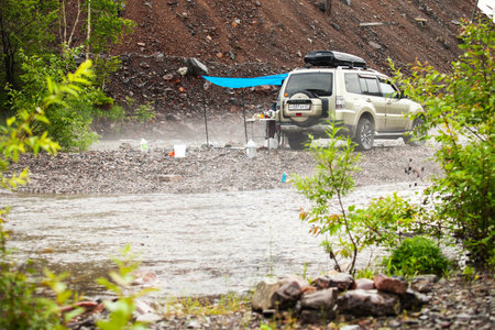 Gorny, Russia - JULY 14, 2021: Car camping at mountain riverのeditorial素材
