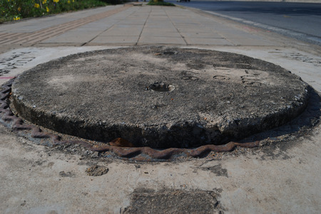 Drain cover that is not completely closedの写真素材