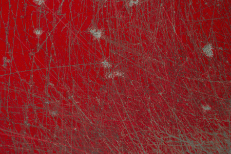 Scratch on the surface of the red deskの写真素材