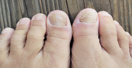 Closeup of woman feet with pedicure on wooden background.の写真素材