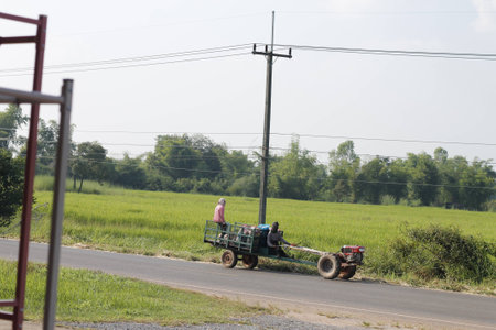 Unique mini tractor and trailer on the main streetの写真素材