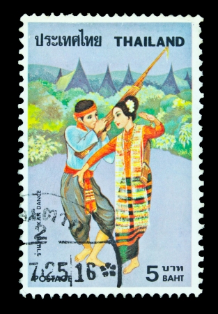 THAILAND - CIRCA 1977  A 4 baht stamp from Thailand  catalogue number Scott 2008 824  shows image of a woman and a man dance, circa 1977のeditorial素材