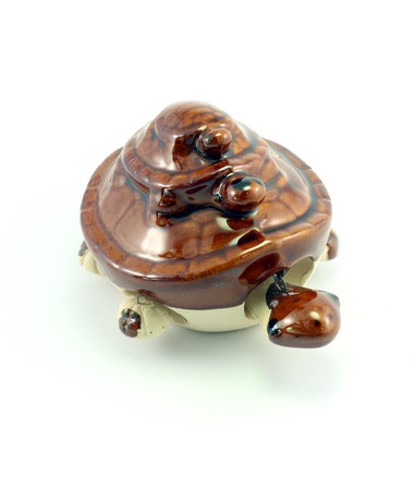 Statue of a turtle on white background.