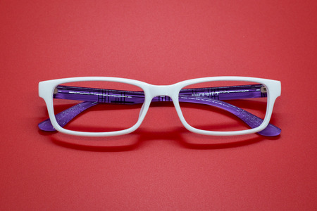 Modern fashionable spectacles on red background, Glassesの写真素材