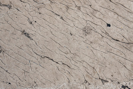 gray concrete wall with cracks. rough surface textureの写真素材