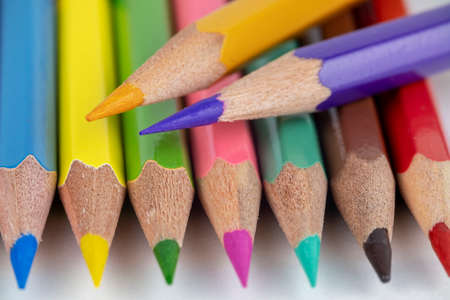 wooden bright colored pencils close up isolated on blurred gray background