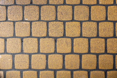 square yellow shabby ceramic tile with dark gray cement. rough surface texture